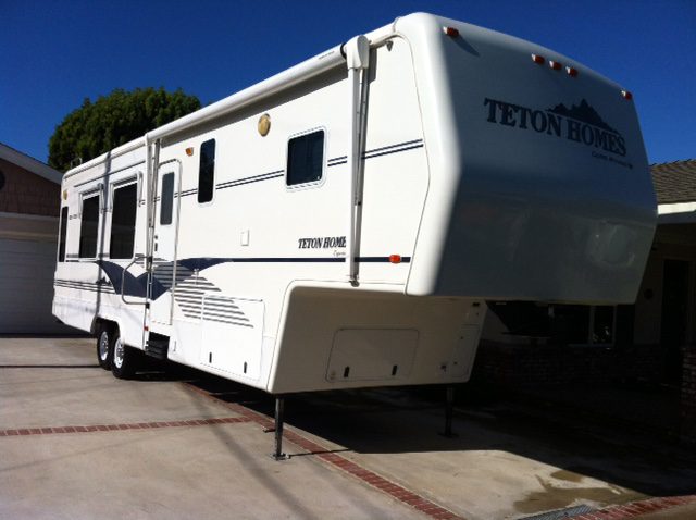 A White Rv Parked in Front of the Garage