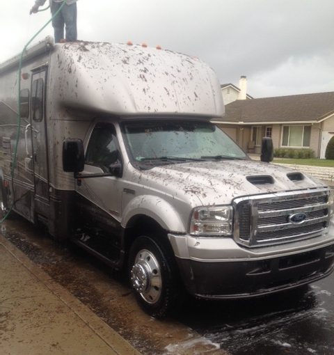 Man Cleaning a Silver Truck